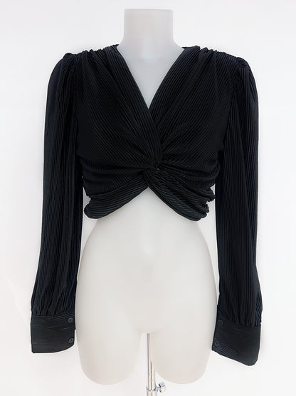 Blusa plisada con nudo frontal